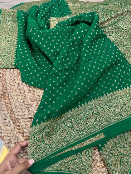 Check out the complete look of this traditional bottle green Banarasi silk saree. The border features a classic paisley motif in gold zari.