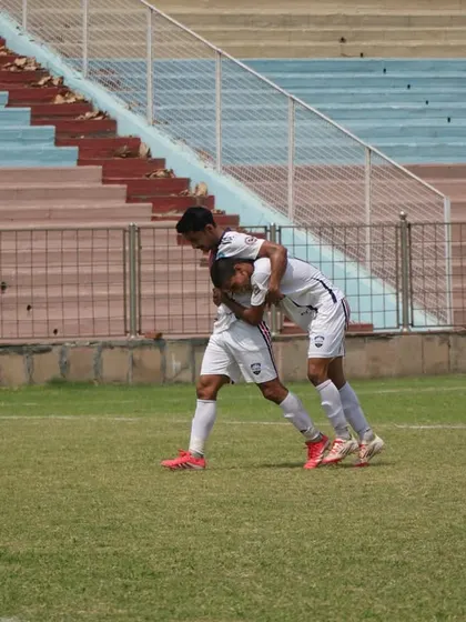 Two players celebrating a crucial moment in the match. Teamwork makes the dream work.