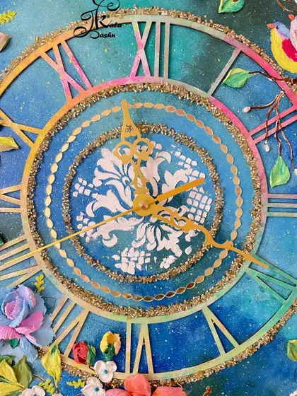 A detailed shot of the clock's center, showing the white stencil design against the cosmic background.