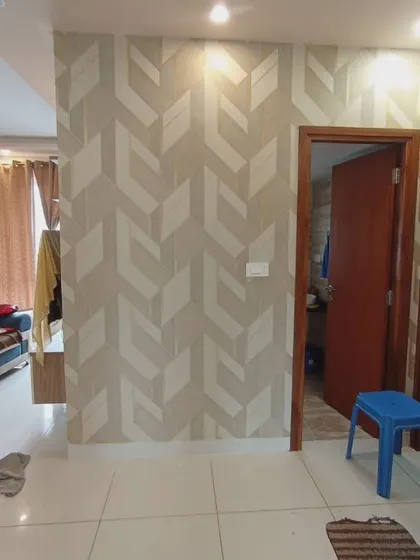 A 3D geometric wallpaper with a chevron or arrow-like pattern in neutral tones.
