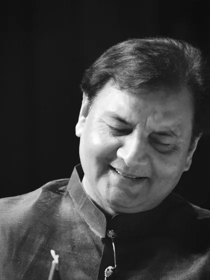 A black and white portrait capturing a moment of quiet satisfaction during a performance.