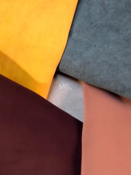 A composition of our premium velvet fabrics in mustard yellow, deep teal, rich burgundy, and soft pink, demonstrating the bold and beautiful color palette we offer.