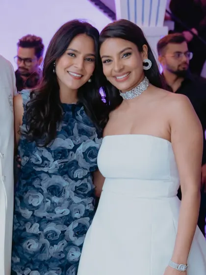 A close-up of the sisters. Both have fresh, glowing skin and makeup that enhances their features for the party.