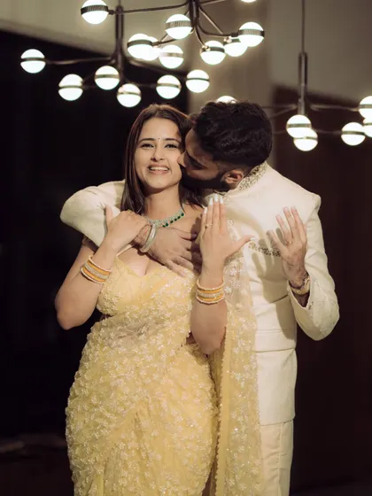 A sweet kiss on the cheek, a classic expression of affection that I capture with a candid, modern feel.
