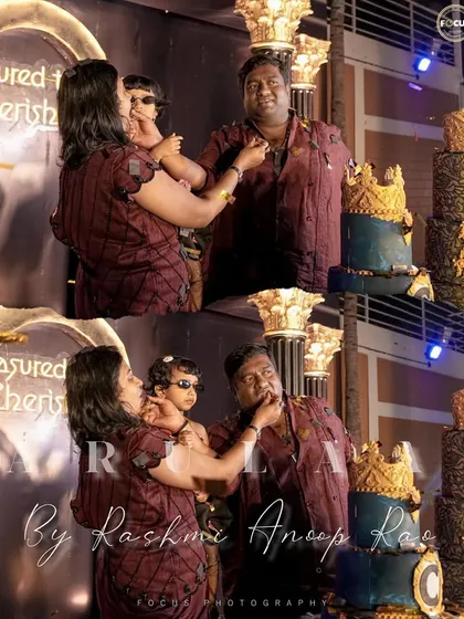 A happy family moment during a cake-cutting ceremony, all looking wonderful in their coordinated maroon outfits.