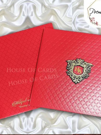 A bold red premium invitation with a textured finish and a custom gold monogram shield, perfect for a grand and passionate statement.