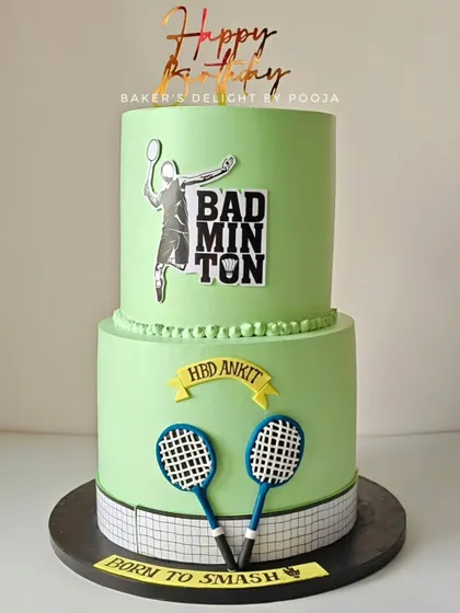 This two-tier cake started as a wedding reception cake but turned into a surprise birthday celebration for the groom, who is a badminton lover. The "Born to Smash" message added a fun, personal touch.