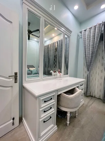 A close-up of the elegant white dressing table from our Haridwar project. The clean lines and classic hardware make it a timeless piece of furniture.