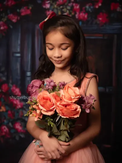 A gentle and serene moment as a young girl smells her bouquet of flowers.