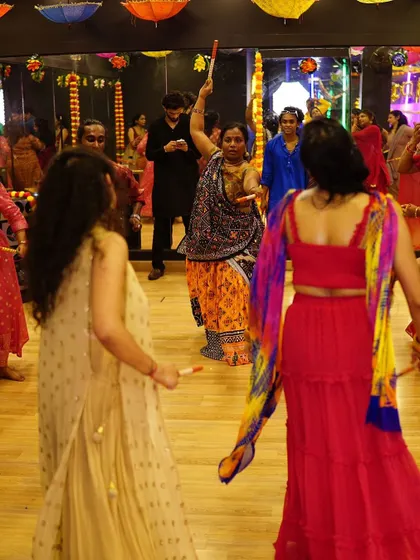 A wide shot of the dance floor, showing multiple groups dancing together. Our workshops prepare everyone for a big, collective celebration.