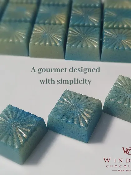 An example of my artistic approach to chocolate making. These gourmet bonbons are colored with cocoa butter to create a beautiful blue shimmer, proving that chocolate can be both delicious and a work of art.
