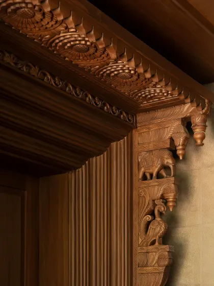 A close-up of the 'karigari' or craftsmanship. This detail of a carved wooden bracket showcases the incredible skill of the artisans and the deep connection to traditional Indian decorative arts.
