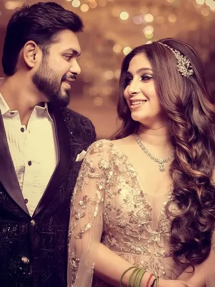 A candid, happy moment between an engaged couple, sharing a look of love and excitement.