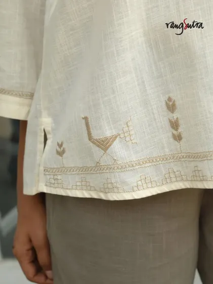 This detail shot from our Bagh collection shows a bird motif embroidered at the hem of a kurta. The harmony of nature's beauty, captured in every stitch, is what makes this collection special.