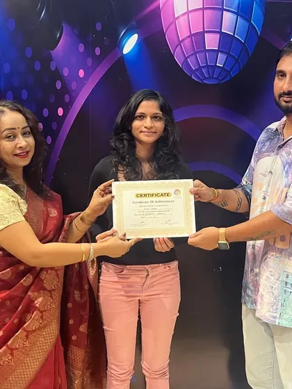 Student Lisha Verat receives her certificate of completion for her vocal course. Congratulations on your well-deserved success.