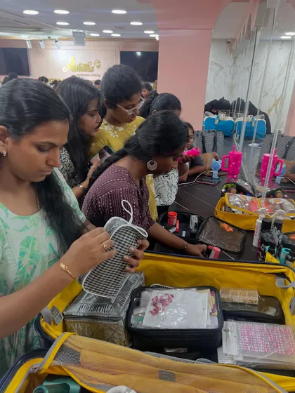 Students learning about product organization and how to pack a professional, travel-friendly makeup kit.