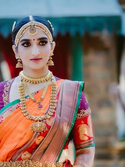A poised shot of the bride, looking directly at the camera, showcasing her complete traditional look.
