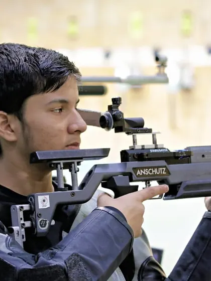 A young shooter demonstrates his technique with an Anschutz rifle. Our coaching focuses on mastering the fundamentals for consistent performance.