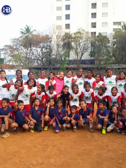 We partner with NGOs to empower kids through sports. This photo shows a happy and diverse group of children in their team uniforms, highlighting our commitment to community development.