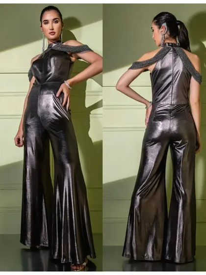 A full front and back view of the metallic gunmetal jumpsuit, showing off its dramatic flared silhouette and unique embellished harness.