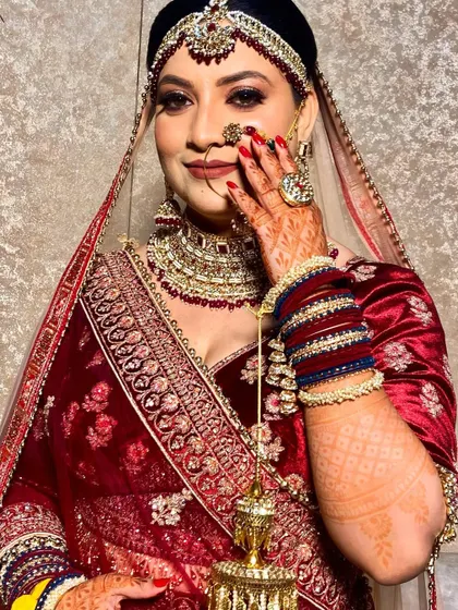 A classic bridal pose. The makeup is designed to be photogenic, ensuring the bride looks perfect in all her wedding photos.