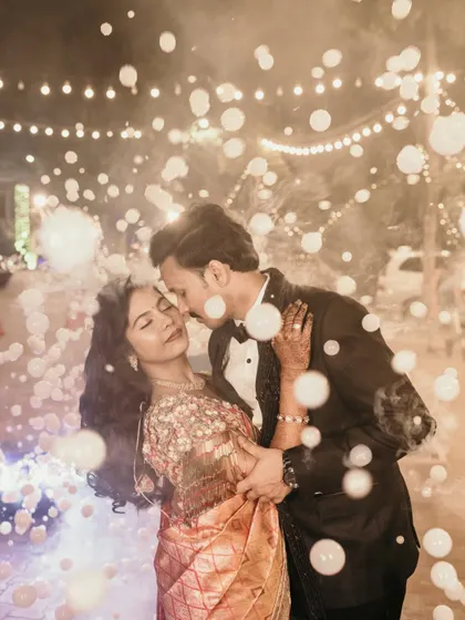 A romantic reception photo with the couple dancing under a shower of bubbles.