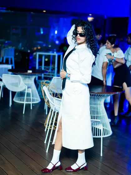 A stylish guest dressed in white, embodying the theme of the party. Our events attract a fashion-conscious crowd that embraces our creative concepts.