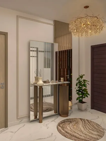 This foyer features a stunning crystal chandelier, a sleek console table with a full-length mirror, and a circular patterned rug on marble flooring.