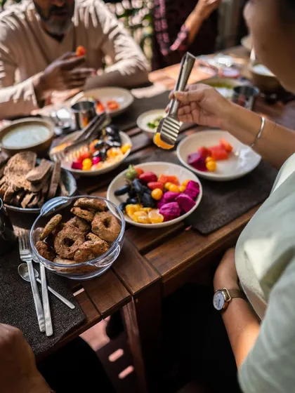 A close-up of a guest enjoying the vibrant fruit platter at our retreat. I emphasize eating a rainbow of colors to ensure a wide range of vitamins, minerals, and antioxidants for optimal health.