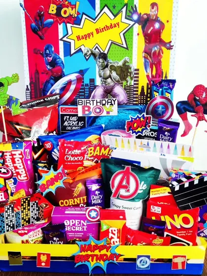 Assemble the ultimate birthday surprise with this vibrant Avengers-themed hamper. It's bursting with color, snacks, and cutouts of favorite superheroes like Iron Man, Captain America, and The Hulk.