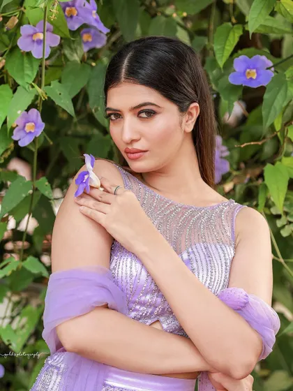 A designer shoot for a modern lavender lehenga. The images were taken in a lush garden, with the purple flowers complementing the color of the outfit, creating a soft and romantic fashion story.