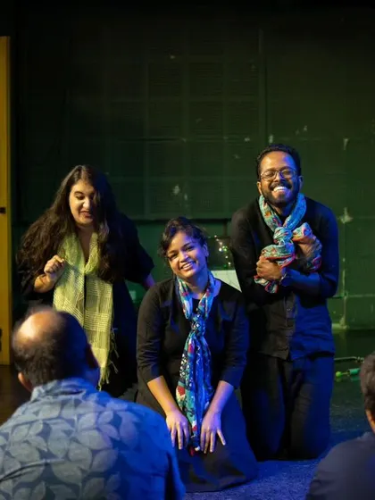Actors from First Drop Theatre during a Playback Theatre performance, creating an intimate and connected moment with the audience.
