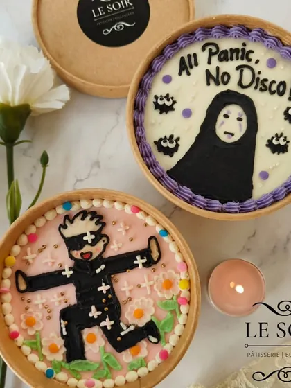 A pair of anime-themed cake tubs ready to go. These custom designs are a great way to surprise a friend with a cake that truly reflects their personality and interests.