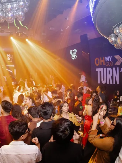 A snapshot of the crowd at a packed event, with everyone lost in the music under the club lights.