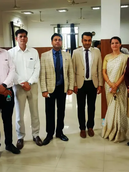 A group photograph with esteemed colleagues at a professional event. Networking and learning from peers is a continuous process.