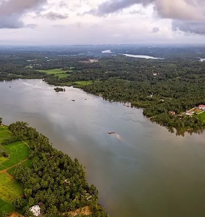 Another perspective of the green backwaters near Udupi. The drone reveals the intricate network of water channels and the vibrant landscape of the coastal region.