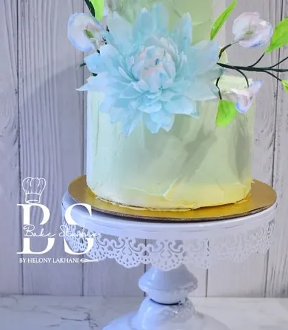 A close-up of a stunning celebration cake from our masterclass finale, featuring delicate wafer paper flowers and a soft pastel finish.