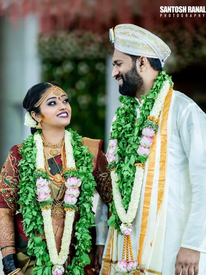A beautiful candid moment between the bride and groom, sharing a smile during their wedding ceremony.