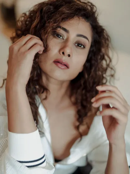 A close-up portrait that feels personal and direct. The focus is entirely on the model's face and expression, capturing a moment of quiet intensity.
