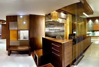 The reception desk at the Egon Zehnder office combined warm wood with panels of metal and leather. The design was meant to feel established and sophisticated, reflecting the nature of the firm.