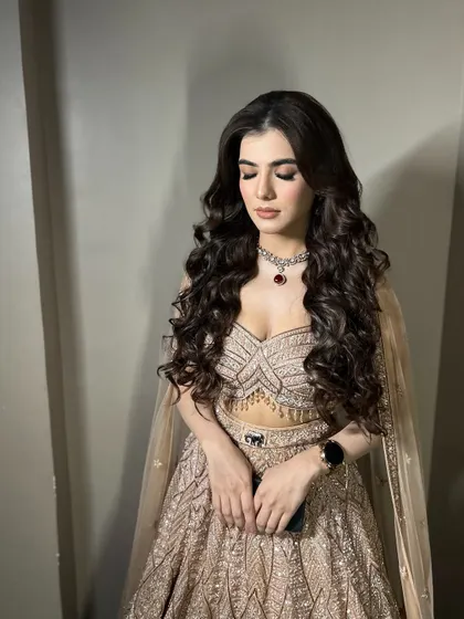 A beautiful shot with her eyes closed, showing the soft, blended eyeshadow that complements her grand outfit.