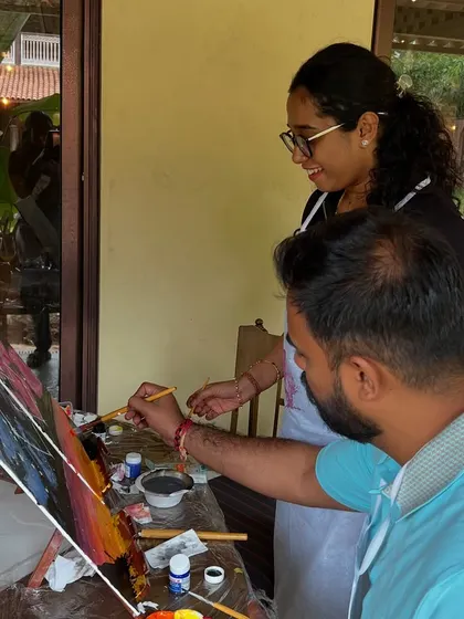 Another angle of our instructor helping a couple with their artwork. Our private sessions are tailored to your pace and preferences.