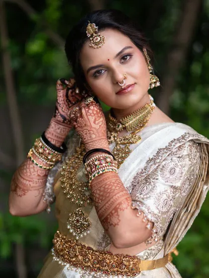A stunning portrait of the bride Sushmitha, where her intricate henna is the perfect accessory to her traditional jewelry.