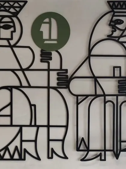 A detail shot showing the Queen and King figures from the 'Queen's Gambit' piece.