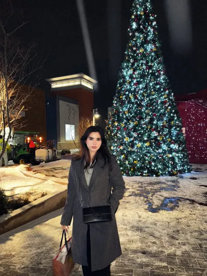 Holiday cheers in front of a giant, lit-up Christmas tree at the Toronto Premium Outlets.