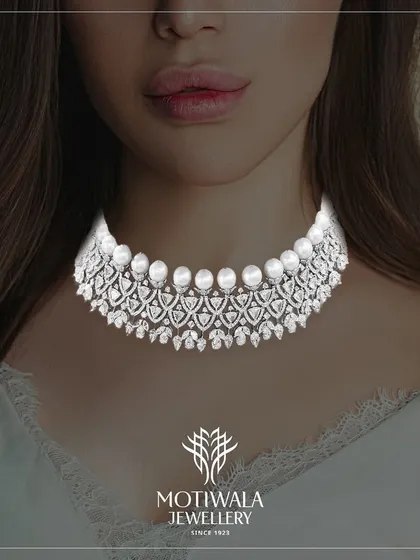 A cascade of brilliance for the modern sophisticate. This diamond and pearl choker necklace offers a contemporary take on classic elegance, featuring rows of lustrous pearls framed by intricate diamond work. It is designed to sit gracefully on the collarbone, making it a perfect statement for evening wear.