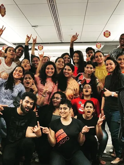 A duplicate shot capturing the amazing vibe with the Amazon team. The peace signs and rock-on gestures say it all. This is what a successful team-building activity feels like.