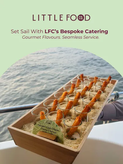 Set sail with our bespoke catering. This image showcases our ability to provide gourmet flavors and seamless service on the water, with appetizers like goat cheese churros served against an ocean backdrop.