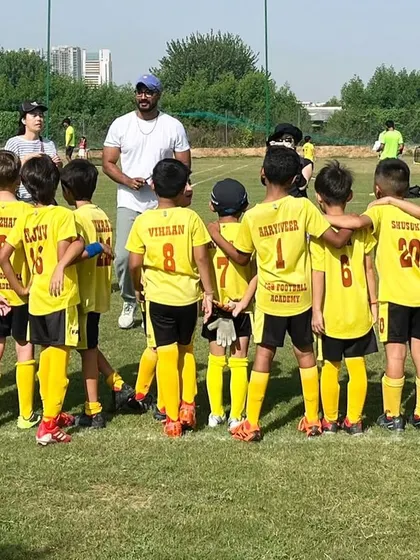 A coach with his team. We foster a love for the game and empower each player to reach their fullest potential.