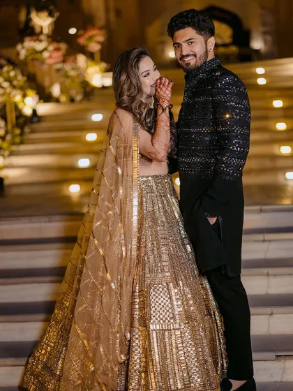 A glamorous portrait of Ishita and Akash on their engagement night, their sparkling outfits matching the festive atmosphere.
